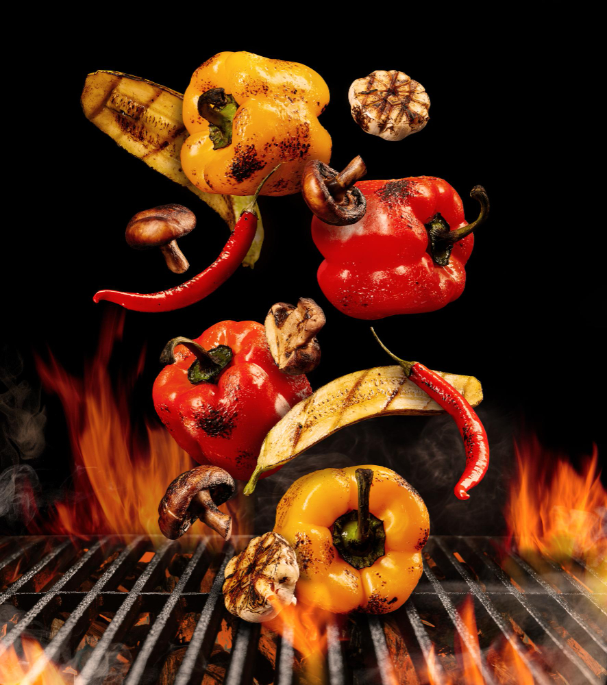 grilled-red-yellow-bell-pepper-zucchini-champignons-chilli-halves-garlic-are-falling-down-black-background-bbq-grill-flaming-fire-charcoal-smoke-cooking-close-up-copy-space